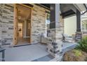 Welcoming front porch with comfortable seating, tasteful decor, and an open doorway view at 4816 Heathshire Dr, Raleigh, NC 27616