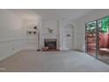 Bright living room featuring a fireplace, built-in shelves, and sliding doors to the outdoor patio at 497 Summerwalk Cir # 497, Chapel Hill, NC 27517