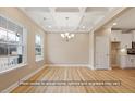 Elegant dining room with tray ceilings, light hardwood floors, and ample natural light at 5516 Jaeger Dr # 75, Graham, NC 27253
