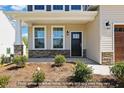 Inviting entrance with stone accents and a stylish front door, complemented by lush landscaping at 5516 Jaeger Dr # 75, Graham, NC 27253