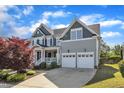Side view of a two-story house featuring an attached garage and landscaped lawn at 602 Alden Bridge Dr, Cary, NC 27519