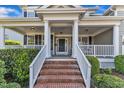 Home's welcoming front porch with white columns and brick steps at 602 Alden Bridge Dr, Cary, NC 27519