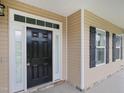 Welcoming front entrance featuring a black door and detailed trim at 63 Whistling Duck Way, Wendell, NC 27591