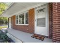 Inviting covered front porch features brick detail and a 'welcome' mat at 6418 Beaver Creek Rd, New Hill, NC 27562