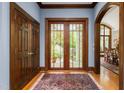 Grand foyer with hardwood floors, beautiful french doors, and custom millwork at 6600(A) Maynard Farm Rd, Chapel Hill, NC 27516