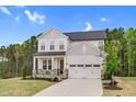 Beautiful home with a two-car garage, a basketball hoop, and a well-maintained front lawn at 67 Comfort Ct, Fuquay Varina, NC 27526
