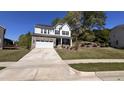 Charming two-story home featuring a stone-accented garage and a long driveway leading to the street at 705 Blue Pointe Path, Apex, NC 27523