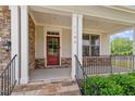 Inviting covered front porch with stone accents and decorative railing provides a welcoming entrance at 7104 Rex Rd, Holly Springs, NC 27540
