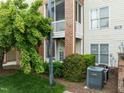 Charming brick building exterior with screened in balcony surrounded by lush landscaping at 712 Portstewart Dr, Cary, NC 27519