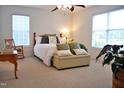 Serene bedroom featuring two windows, a comfortable bed, and neutral decor for a relaxing ambiance at 738 Aspenwood Dr, Graham, NC 27253