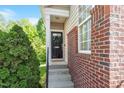 Charming front door with wreath, brick accents, and stone steps leading to the entrance at 7838 Spungold St, Raleigh, NC 27617