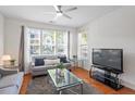 Cozy living room with neutral walls, plenty of natural light and a flatscreen TV at 7838 Spungold St, Raleigh, NC 27617