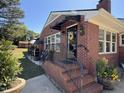 Charming brick home featuring a covered front entrance with wrought iron railings at 901 Vandora Ave, Garner, NC 27529