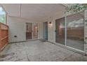 Covered outdoor patio featuring sliding glass doors and an entrance door at 497 Summerwalk Cir # 497, Chapel Hill, NC 27517