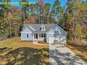 Charming single-Gathering home featuring a well-manicured lawn and attached two-car garage at 95 Autumnwood Ln, Spring Hope, NC 27882