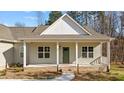 Inviting single-story home featuring a welcoming front porch and manicured landscaping at 95 Leisure Ln # 9, Louisburg, NC 27549