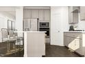Stylish kitchen featuring gray cabinets, stainless steel appliances, and a breakfast bar at 1012 Red Roses Ave, Durham, NC 27703