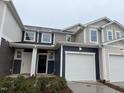 Charming townhome featuring a two-car garage and modern architectural details at 1031 Mountain Crown St, Durham, NC 27703