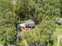 Aerial view of a home nestled among mature trees, showcasing its well-maintained yard at 10609 Lowery Dr, Raleigh, NC 27615