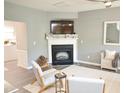 Bright living room featuring a fireplace and neutral furnishings at 10943 Pendragon Pl, Raleigh, NC 27614