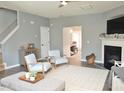 A living room with gray walls, light-colored furnishings, and a fireplace at 10943 Pendragon Pl, Raleigh, NC 27614