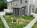 Aerial view of a fenced backyard with a fire pit and screened-in porch at 1109 Renewal Pl, Raleigh, NC 27603