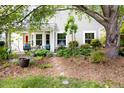 Beautifully landscaped backyard featuring a patio, seating area, and mature trees for shade and privacy at 111 Sir Richard Ln, Chapel Hill, NC 27517
