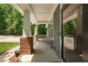 Inviting front porch featuring classic columns and ample space for outdoor seating at 11808 Venture Oak Way, Raleigh, NC 27613