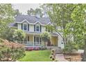 Charming two-story home with a welcoming front porch, landscaped yard, and classic architectural details at 1203 Queensbury Cir, Durham, NC 27713