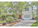 Charming two-story home with a welcoming front porch and a well-maintained lawn at 1203 Queensbury Cir, Durham, NC 27713