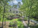 Aerial view of a charming home with well-maintained landscaping and mature trees, offering great curb appeal at 1203 Queensbury Cir, Durham, NC 27713