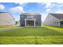 Spacious backyard with green lawn and patio, perfect for outdoor activities at 1302 Cricket St, Elon, NC 27244