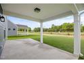 Covered outdoor patio space is ideal for entertaining and relaxing at 1302 Cricket St, Elon, NC 27244
