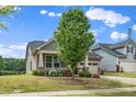Beautiful home featuring a welcoming front porch and well-maintained landscaping, enhancing its curb appeal at 1305 Chronicle Dr, Durham, NC 27703