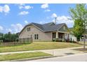 Lovely home showcasing a charming front porch, beautifully landscaped lawn, and a serene backyard view at 1305 Chronicle Dr, Durham, NC 27703