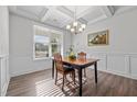 Bright dining area with wainscoting, coffered ceiling, and large windows at 1320 Abington Dr, Mebane, NC 27302