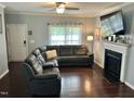 Comfortable living room with a fireplace and a large sectional couch, perfect for relaxing and entertaining at 1320 Double Oak Ln, Willow Springs, NC 27592