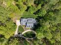 An aerial view of a beautiful home surrounded by lush greenery and a winding driveway at 1415 Meadow Wind Ln, Hillsborough, NC 27278