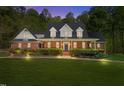Charming brick home with covered front porch and professionally landscaped lawn at 1415 Meadow Wind Ln, Hillsborough, NC 27278