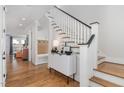 Bright foyer with hardwood floors, a staircase, and a custom storage bench at 1422 Banbury Rd, Raleigh, NC 27607