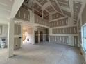Bright living room showing drywall installation, fireplace, and doorways to other rooms at 1611 S Old Carriage Rd, Rocky Mount, NC 27804