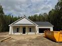 Charming single-story home with gray siding, a dark gray roof, and an attached garage at 200 Green Pines Estates Dr, Kenly, NC 27542
