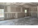 Spacious living room features freshly installed drywall, awaiting your personal design touches at 200 Green Pines Estates Dr, Kenly, NC 27542