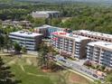 Aerial view of the condo building showcasing it's location near a golf course at 2402 Environ Way # Bldg 2000, Chapel Hill, NC 27517