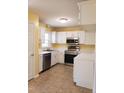 Well-lit kitchen featuring stainless steel appliances and ample counter space at 2416 Fields Of Broadlands Dr, Raleigh, NC 27604