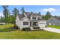 Beautifully landscaped two-story home with a covered front porch, two-car garage and scenic backyard at 257 Reese Dr, Willow Springs, NC 27592