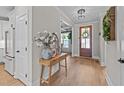 Welcoming foyer with hardwood floors, decorative table, and views into the adjacent living spaces at 257 Reese Dr, Willow Springs, NC 27592