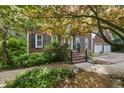 Brick home featuring a two-car garage, landscaping, and traditional design elements at 2607 Buffaloe Rd, Garner, NC 27529