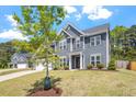Attractive two-story home with a well-kept lawn and landscaping, under a cloudy, blue sky at 30 Dowdy Ct, Youngsville, NC 27596