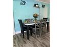 Dining room featuring a modern table setting, light wood grain floors, and aqua colored walls at 307 S Smithfield Rd, Knightdale, NC 27545